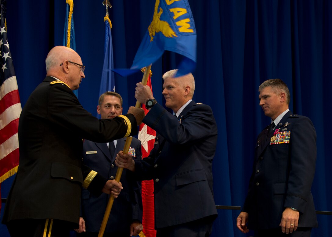 Col. James Johnson, center, receives command of the 133rd Airlift Wing from Maj. Gen. Richard Nash, left, Minnesota Adjutant General in St. Paul, Minn., Aug. 18, 2013.
(U.S. Air National Guard photo by Tech. Sgt. Amy M. Lovgren/Released)
