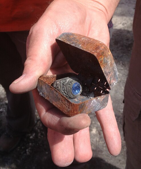 Homeowner Willy Scott, Black Forest, Colo. opened a box volunteers discovered in his destroyed garage. He was amazed to find his son-in-law’s U.S. Air Force Academy ring. Volunteers from the 39th Aerial Port Squadron discovered the box while they were helping out with Black Forest fire clean-up efforts. (U.S. Air Force photo/Senior Airman Teresa Black)