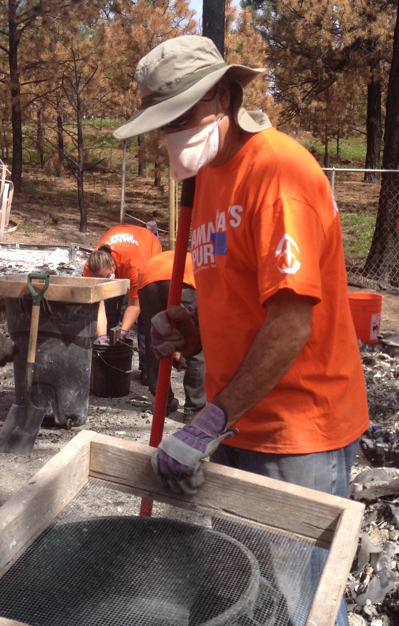 Tech. Sgt. Andy Acosta operates a sifter while looking for items that survived a garage fire in Black Forest, Colo. He was a member of the 39th Aerial Port Squadron volunteers that took time over a weekend during annual training to help those who lost homes and other structures during the June fire that destroyed almost 500 structures. (U.S. Air Force photo/Senior Airman Teresa Black)