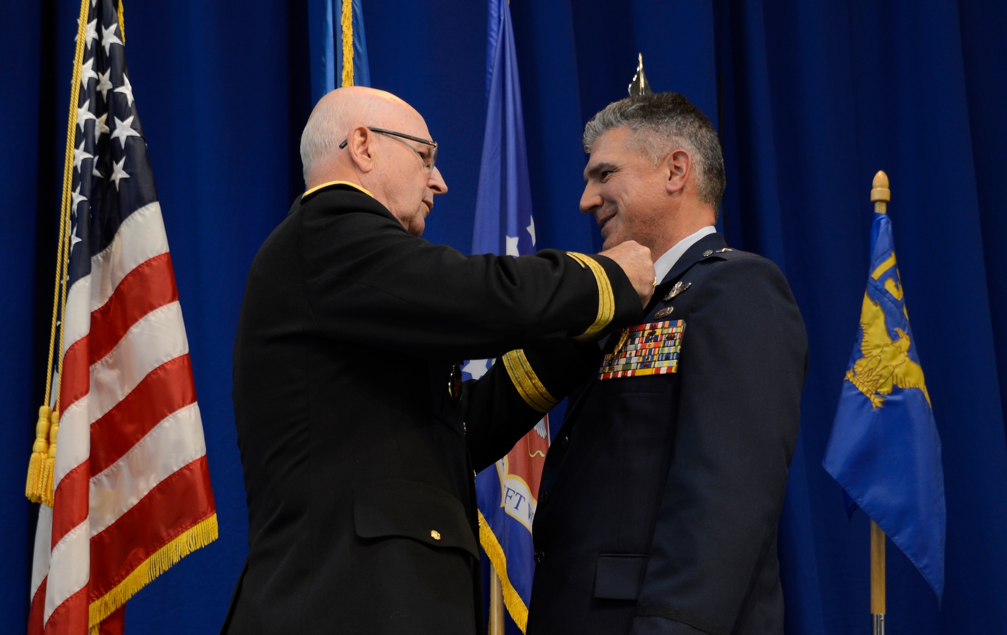 Maj. Gen. Richard Nash, left, Minnesota Adjutant General, presents The Legion of Merit to Brig. Gen. Greg Haase, outgoing 133rd Airlift Wing commander in St. Paul, Minn., Aug. 18, 2013.  (U.S. Air National Guard photo by Tech. Sgt. Amy M. Lovgren/Released)