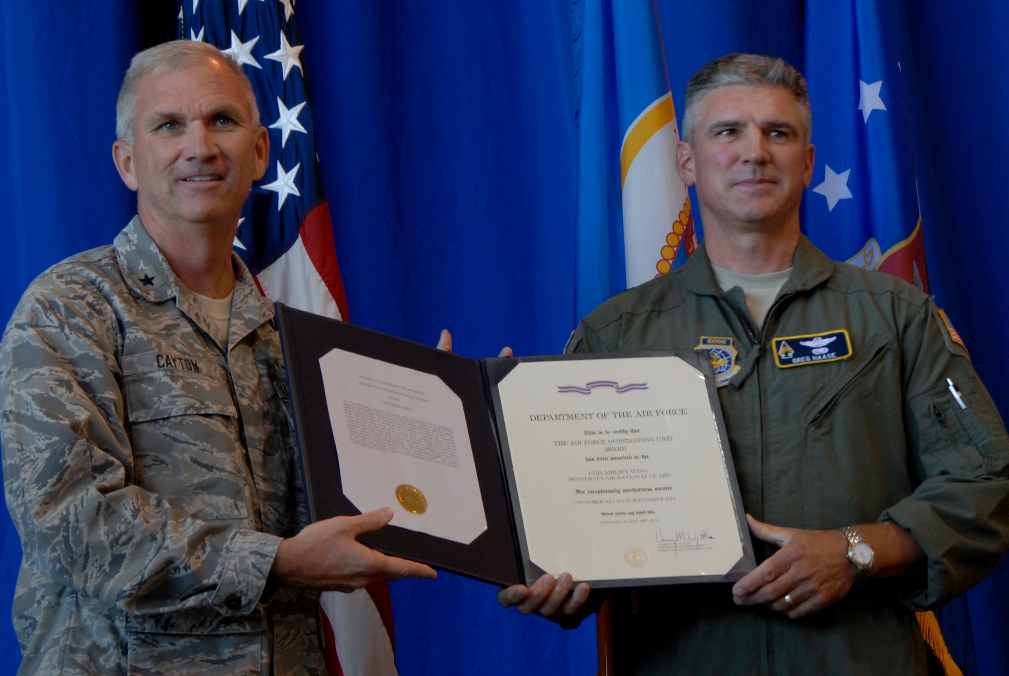 Brig. Gen. Robert Cayton, Chief of Staff for Air, Joint Force Headquarters, Minnesota National Guard, left, presents the Outstanding Unit Award to Brig. Gen. Greg Haase, Commander of the 133rd Airlift Wing in St. Paul, Minn., Aug. 17, 2013.

(U.S. Air National Guard photo by Senior Airman Kari Giles/ Released)

