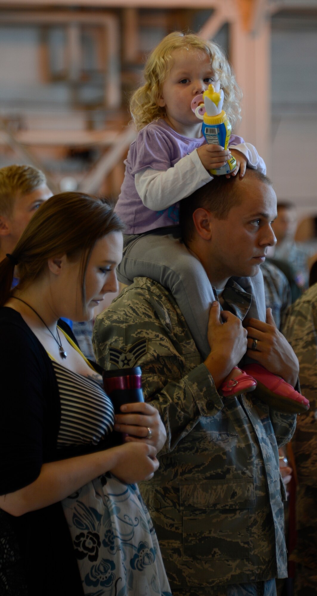 Airmen from the 133rd Airlift Wing and their families listen to the opening ceremony of Family Day in St. Paul, Minn., Aug. 17, 2013.  Family Day is an annual event that recognizes the families and thanks them for their support to the Airmen.
(U.S. Air National Guard photo by Tech. Amy M. Lovgren/Released)

