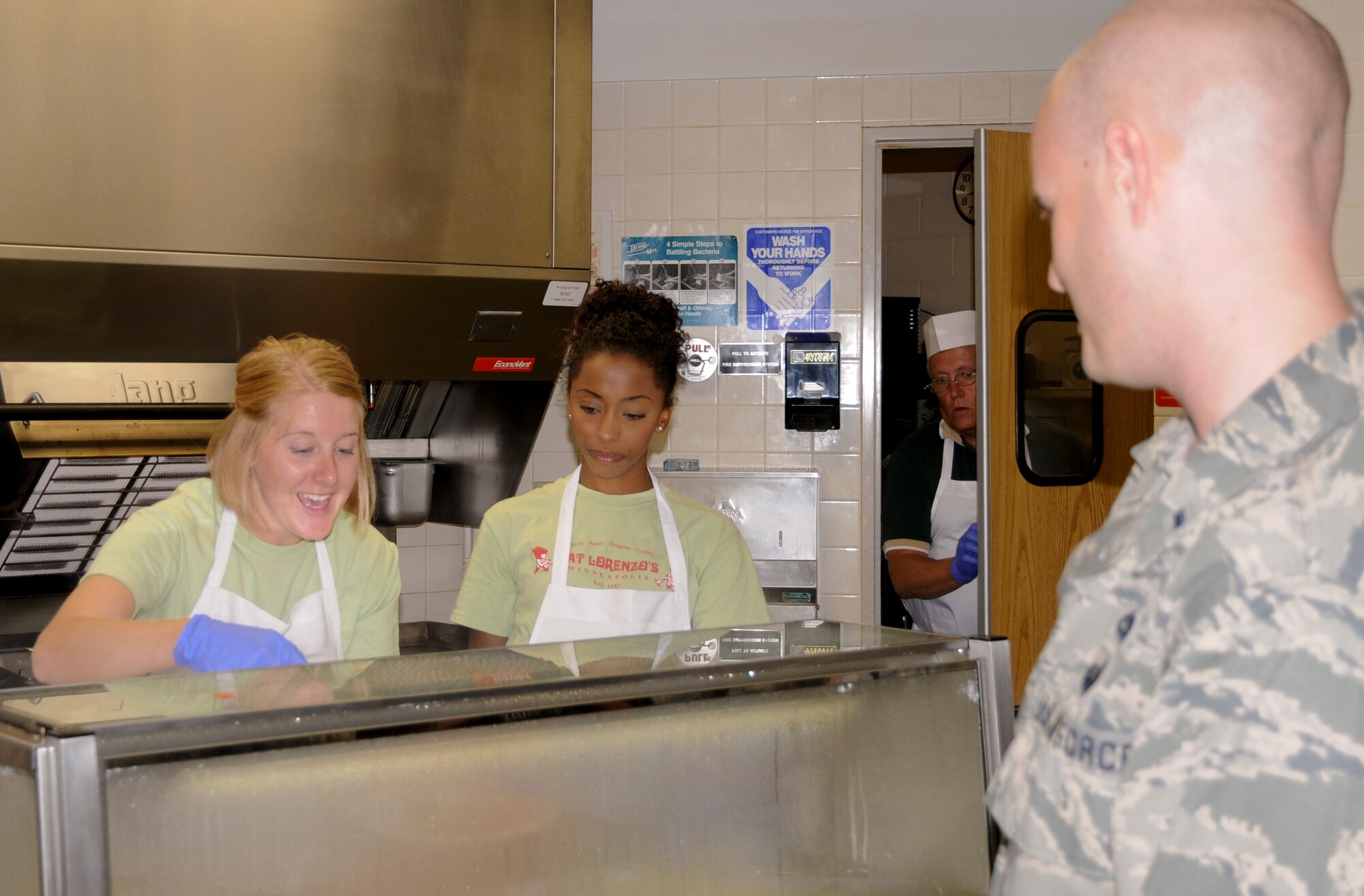Employees of Fat Lorenzo’s, serve their signature Italian dishes at the annual Family Day event in St. Paul, Minn., Aug. 17, 2013.  Fat Lorenzo’s has been serving their meals at Family Day for the last couple of years, as a way to say thank you to the Airmen.
(U.S. Air National Guard photo by Senior Airman Kennith Veillon/Released)
