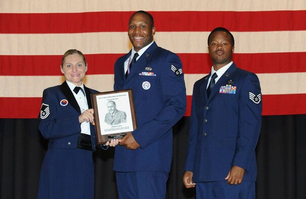 Master Sgt. Rachael Hall, Commandant of the McConnell Air Force Base Airman Leadership School presents Senior Airman Bohannon Stephens of the 911th Airlift Wing with the Commandant Award at his ALS graduation, June 27, 2013 at McConnell Air Force Base, Kan. The commandant award is given to the Airman that displayed significant contributions to the overall success of the class and exemplified professional military qualities in leadership.  The five-week-long course focused on teaching military professionalism, leadership skills, supervisory skills, and effective means of communication prepares senior airmen to be professional NCOs who can supervise and lead Airmen. (U.S. Air Force Courtesy photo by McConnell Airman Leadership School)