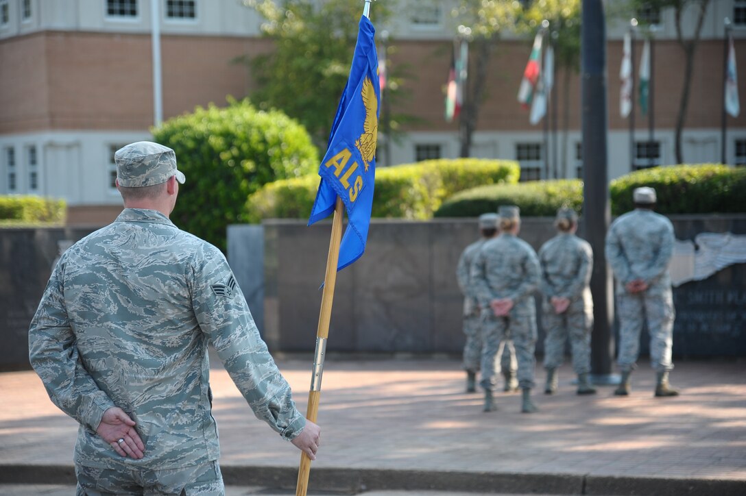 Senior Airman Christopher Saunders, 14th Contracting Squadron, stands at parade rest awaiting the sounding of Retreat at the Airman Leadership School Retreat Ceremony Aug. 15 at the flag pole outside of the 14th Flying Training Wing building.  The ALS class will graduate on Sept. 4 at the Columbus Club.  (U.S. Air Force Photo/Airman 1st Class Charles Dickens)