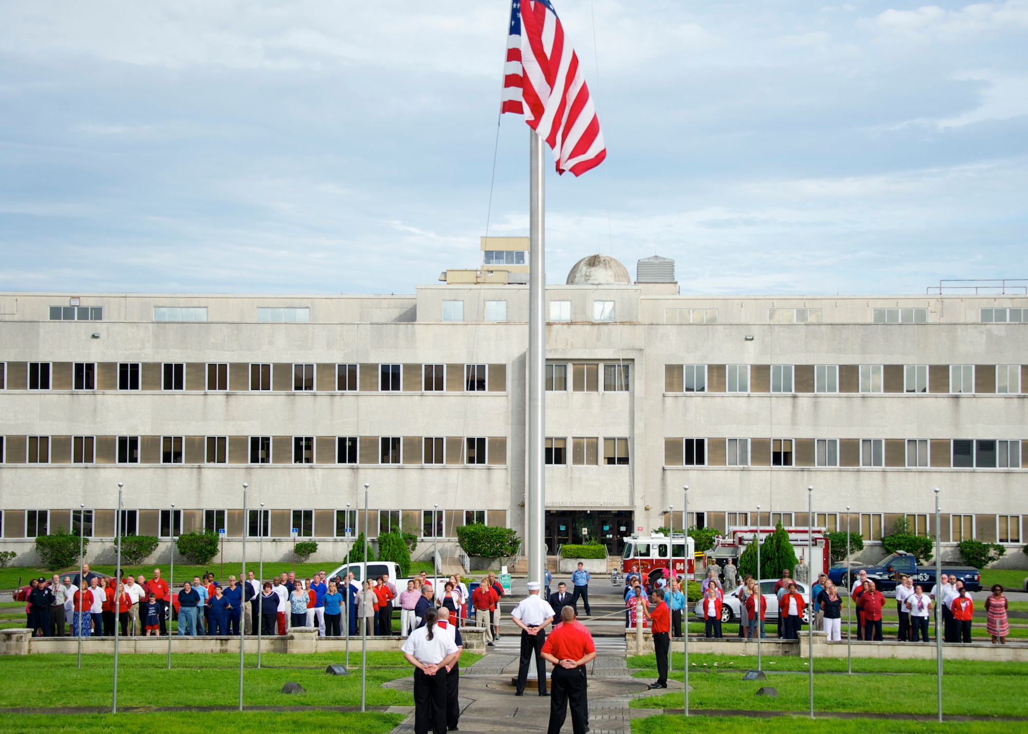 Civilian employees of Team Eglin stand in formation in front of the installation headquarters building during a base weekly retreat ceremony Aug. 22.  It was the first time the flights and flag detail performing the ceremony were made up of all civilians who presented the colors to Brig. Gen. David Harris, 96th Test Wing commander. Organizers of the event sought at least 35 patriotic Americans ready to stand up for their nation and they met their quota.  (U.S. Air Force photo/Sara Vidoni)