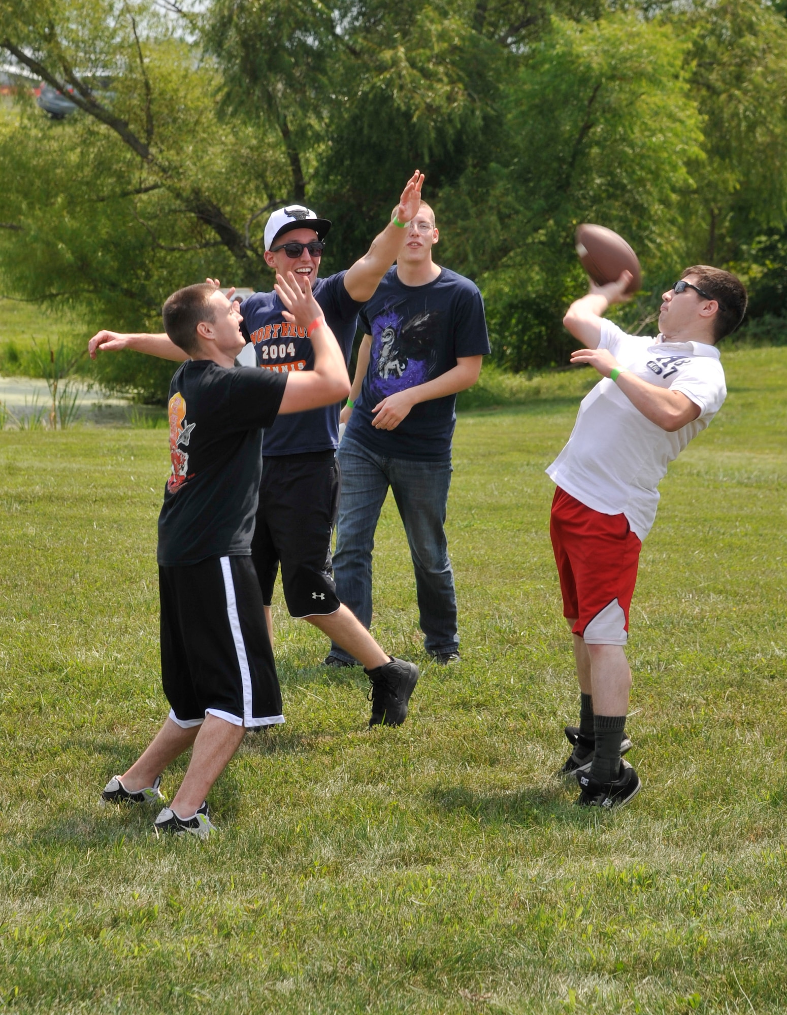 Airmen from the 509th Bomb Wing enjoy a game of football at Whiteman Air Force Base, Mo., Aug. 16, 2013. Airmen took advantage of the opportunity to relax and enjoy themselves. (U.S. Air Force photo by Airman 1st Class Keenan Berry/Released)