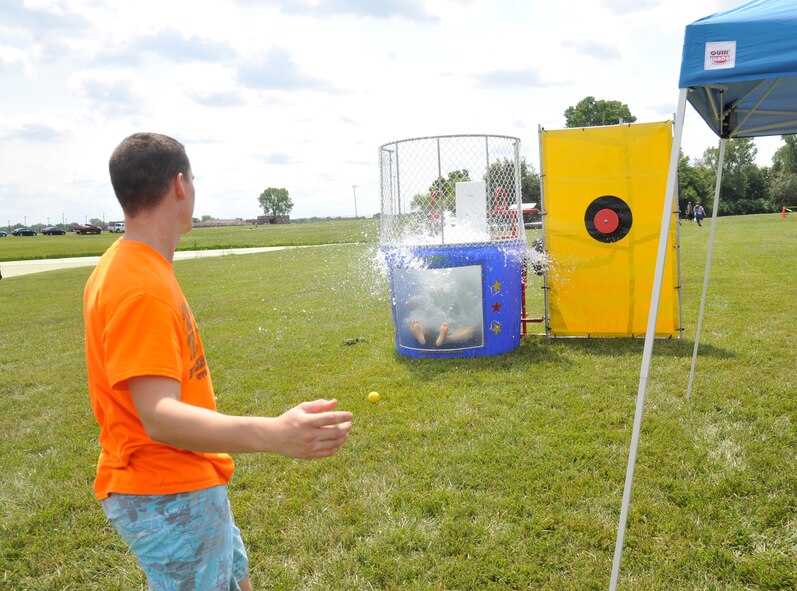 An Airman from the 509th Bomb Wing throws a ball at the dunk tanks lever during the Atomic Luau at Whiteman Air Force Base, Mo., Aug. 16, 2013. This activity was inspired by Airmen and aimed to relieve stress and have fun. (U.S. Air Force photo by Airman 1st Class Keenan Berry/Released)