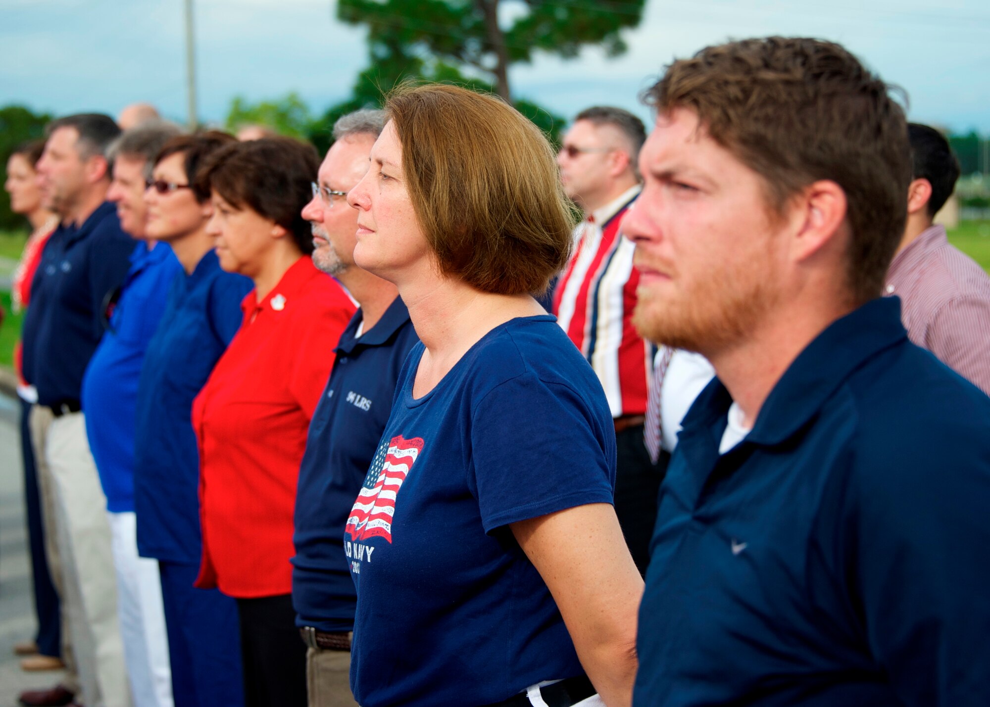 Civilian employees of Team Eglin stand in formation in front of the installation headquarters building during a base weekly retreat ceremony Aug. 22.  It was the first time the flights and flag detail performing the ceremony were made up of all civilians who presented the colors to Brig. Gen. David Harris, 96th Test Wing commander. Organizers of the event sought at least 35 patriotic Americans ready to stand up for their nation and they met their quota.  (U.S. Air Force photo/Sara Vidoni)