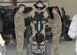 Explosive ordinance disposal Airmen offer assistance as an Airman attempts to operate a Segway while wearing an EOD bomb suit at the 64th Air Expeditionary Group in Southwest Asia, July 26, 2013. The 64th AEG EOD team hosted a two-day open house allowing 64th AEG Airmen an opportunity to learn about their operations and equipment.  (U.S Air Force photo/Staff Sgt. Minerva H. Rosario)