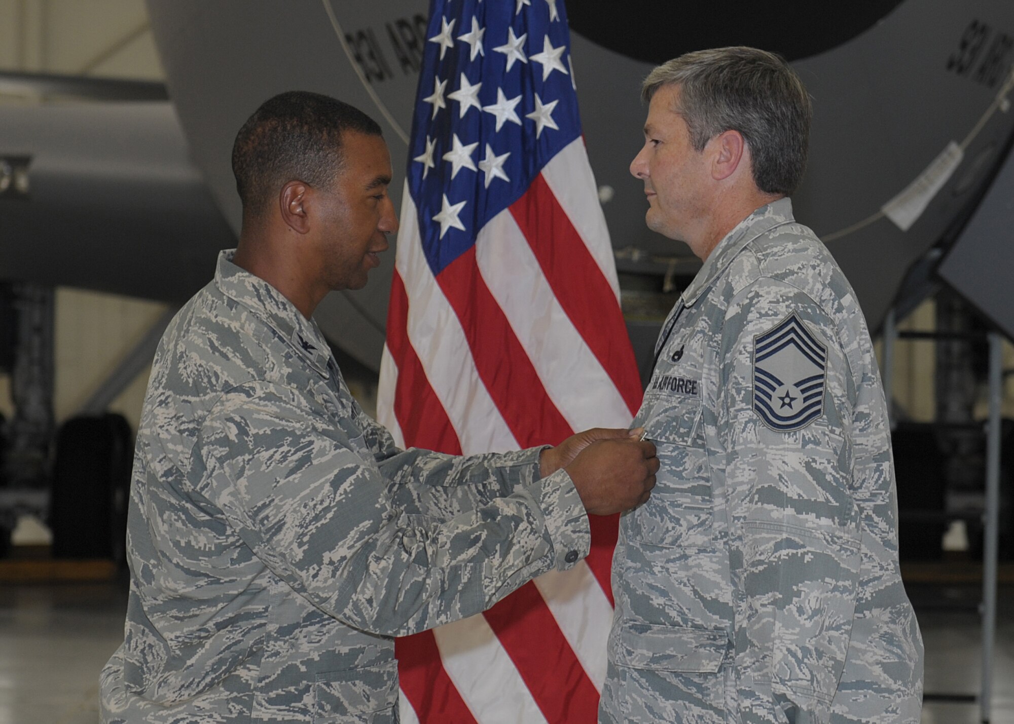 Col. Eric Faison, 22nd Maintenance Group commander, pins a Bronze Star Medal on Chief Master Sgt. Mark Clegg, 22nd Maintenance Squadron superintendent, Aug. 16, 2013, at McConnell Air Force Base, Kan. Clegg managed the Air Expeditionary Force and Enabler rotations of approximately 650 personnel from 53 bases, encompassing 18 different Air Force specialty codes during his most recent deployment. The 376th Air Expeditionary Wing was able to generate more than 3,926 sorties and 14,120 combat flying hours, off-loading more than 222 million pounds of fuel to 16,400 coalition receivers because of Clegg’s efforts. (U.S. Air Force photo/Senior Airman Katrina M. Brisbin)