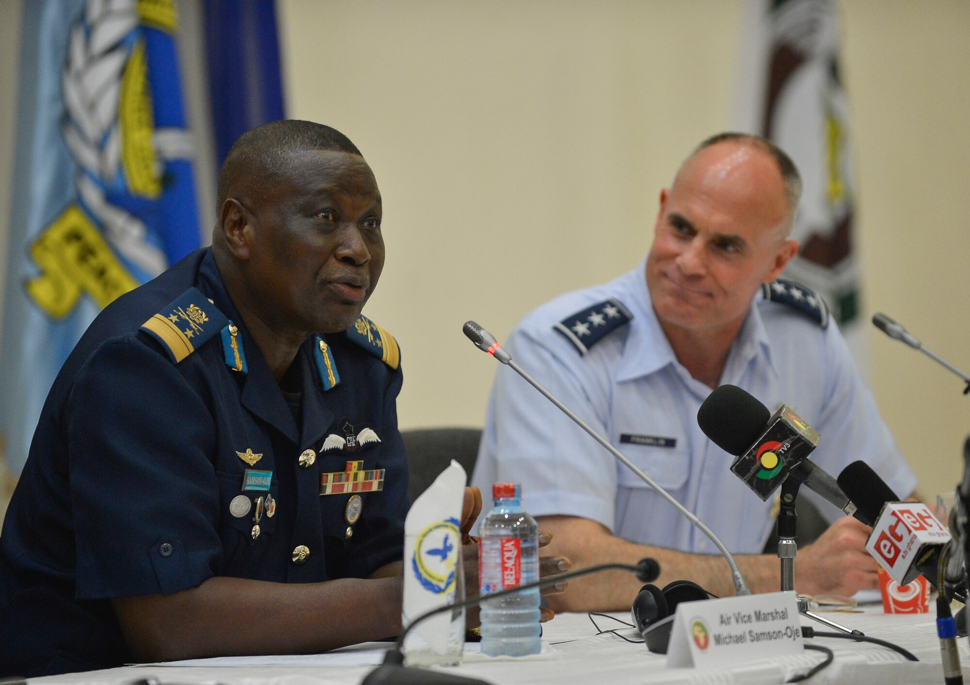 Cohosts Air Vice Marshal Michael Samson-Oje, Ghanaian chief of air staff (Left), and Lt. Gen. Craig A. Franklin, 3rd Air Force commander (Right), take questions during a press conference after the closing ceremony of the Regional African Air Chiefs Symposium, Aug. 22, 2013, in Accra, Ghana. The RAACS brings air chiefs together to discuss how their unique capabilities can be collaborated to resolve regional challenges. (U.S. Air Force photo by Airman 1st Class Jordan Castelan/Released)
