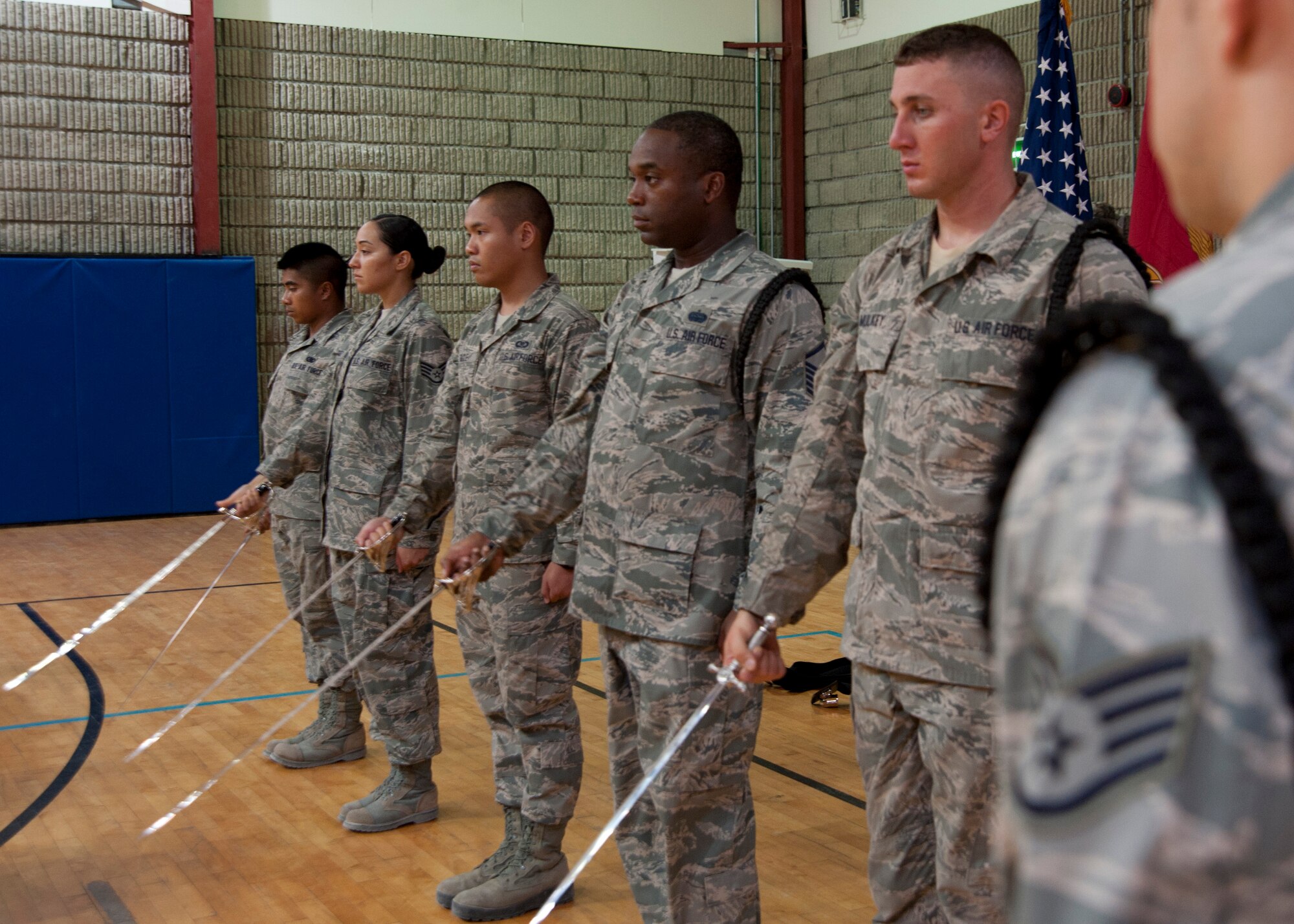Under the command of Staff Sgt. Stephen Dimando, honor guardsmen learn saber manuals during a weekly practice at the 379th Air Expeditionary Wing in Southwest Asia, Aug. 19, 2013. Dimando is an honor guard trainer here deployed from Joint Base San Antonio-Randolph, Texas, and hails from San Antonio, Texas. (U.S. Air Force photo/Senior Airman Bahja J. Jones) 