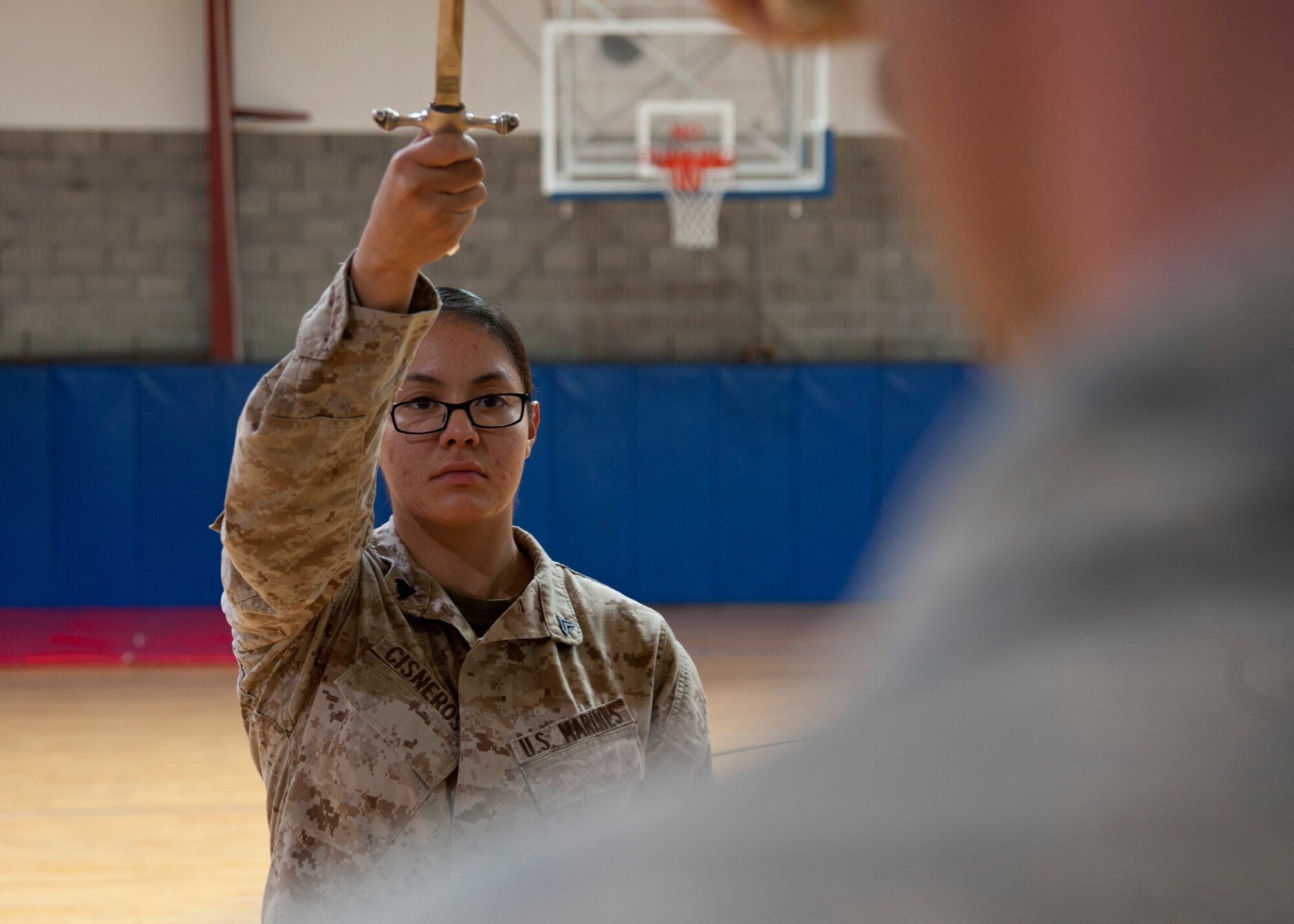 Marine Cpl. Josefina Cisneros extends her saber at the command “present arms” during a weekly honor guard practice at the 379th Air Expeditionary Wing in Southwest Asia, Aug. 19, 2013. Cisneros is a VMR detachment administrative clerk deployed from Marine Corps Air Station Miramar, Calif., and a Boise, Idaho native. 

