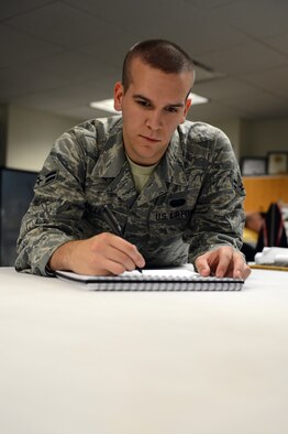 Airman 1st Class Travis Gallegos, 627th Communications Squadron cyber systems operator, sketches out a design Aug. 20, 2013, for his next poster project at Joint Base Lewis-McChord, Wash. Gallegos designed the Sexual Assault Response and Prevention poster which will be hung in the McChord Field dormitories to help raise sexual assault awareness. (U.S. Air Force photo/Airman 1st Class Jacob Jimenez)