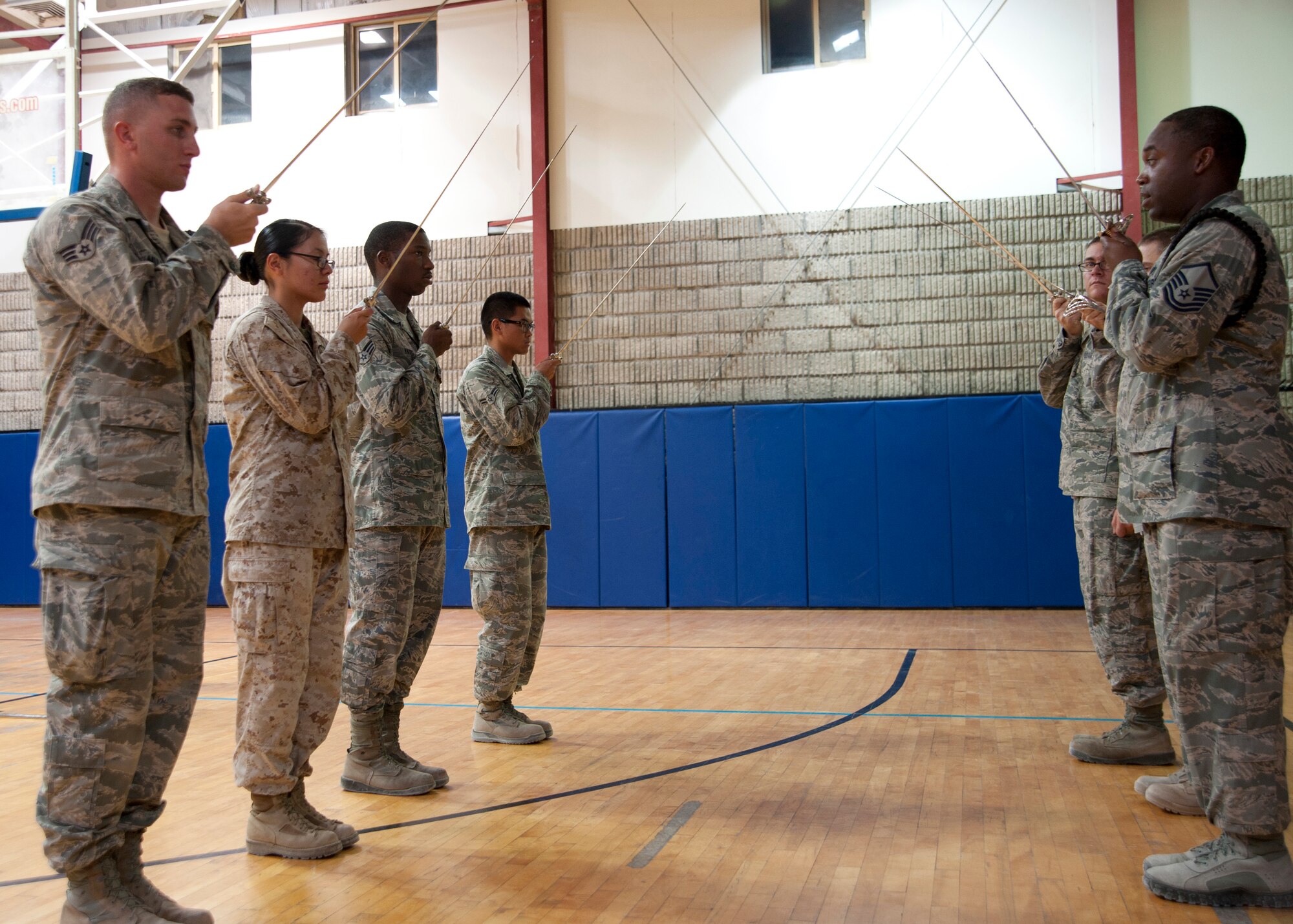 Honor guardsmen learn to execute saber manuals during a weekly practice at the 379th Air Expeditionary Wing in Southwest Asia, Aug. 19, 2013. The base honor guard’s primary tasking is to support unit and morale functions. (U.S. Air Force photo/Senior Airman Bahja J. Jones) 