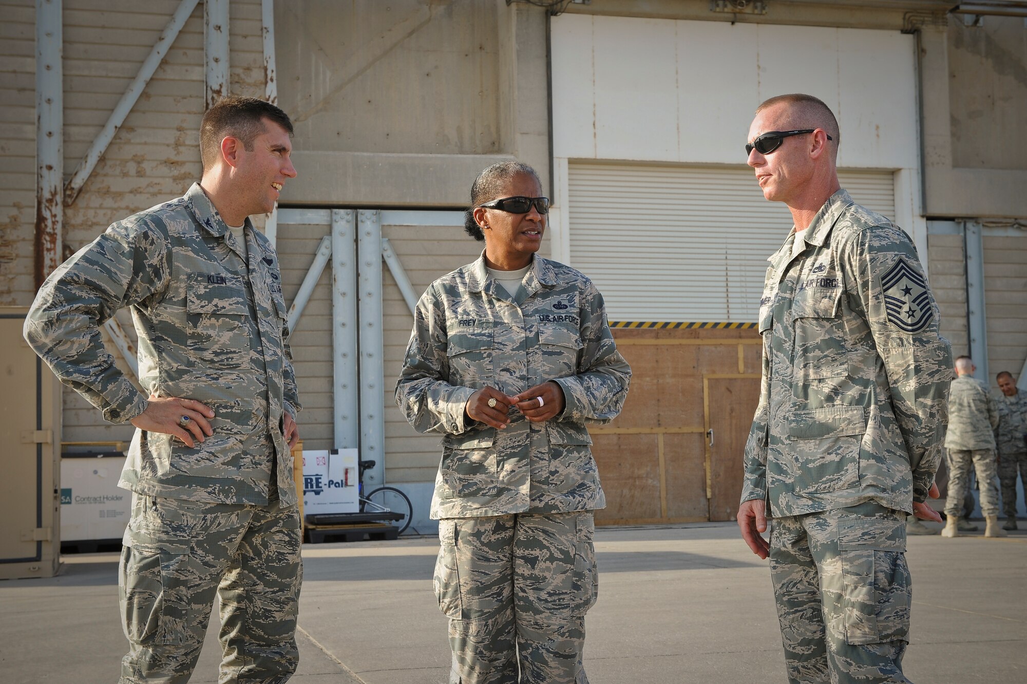 AFCENT Command Chief Master Sergeant Shelina E. Frey chats with Col. John
Klein Jr., 386th Air Expeditionary Wing commander and Chief Master Sgt. John
Weimer, 386 AEW command chief, during her visit to the base, undisclosed
location in Southwest Asia, August 20, 2013. Frey, the Command Chief Master
Sergeant of Air Forces Central Command, Southwest Asia, serves as the
commander's advisor regarding issues of the health, morale, welfare of the
enlisted force.  (U.S. Air Force Photo by 1st Lt. Nathan Wallin)