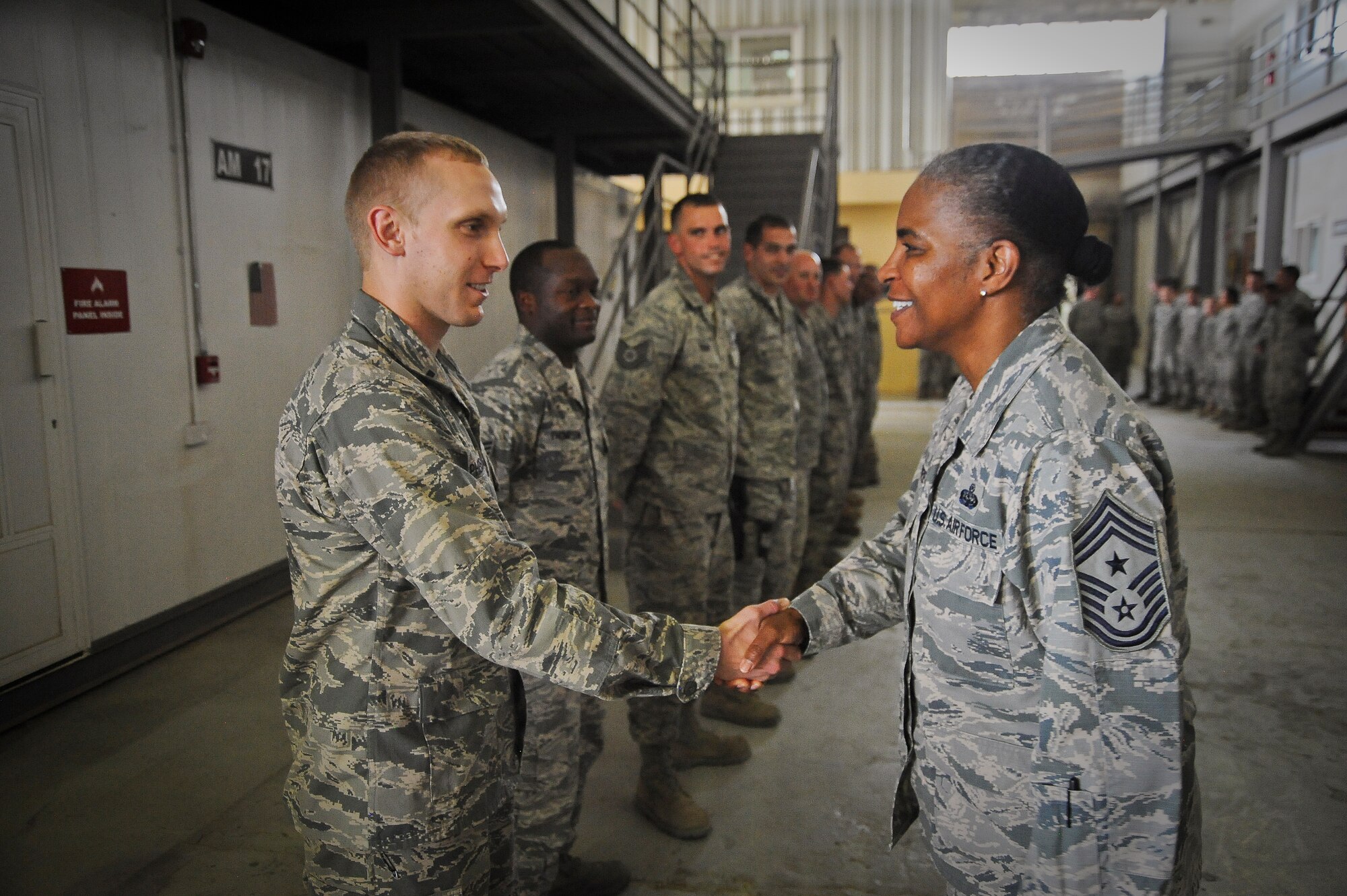 AFCENT Command Chief Master Sergeant Shelina E. Frey is greeted by 387th
Expeditionary Support Squadron Civil Engineer Flight commander 1st Lt.
Andrew McPherson, undisclosed location in Southwest Asia, Aug. 21, 2013.
Frey, the Command Chief Master Sergeant of Air Forces Central Command,
Southwest Asia, serves as the commander's advisor regarding issues of the
health, morale, welfare of the enlisted force.  (U.S. Air Force Photo by
Master Sgt. Chris Campbell)

