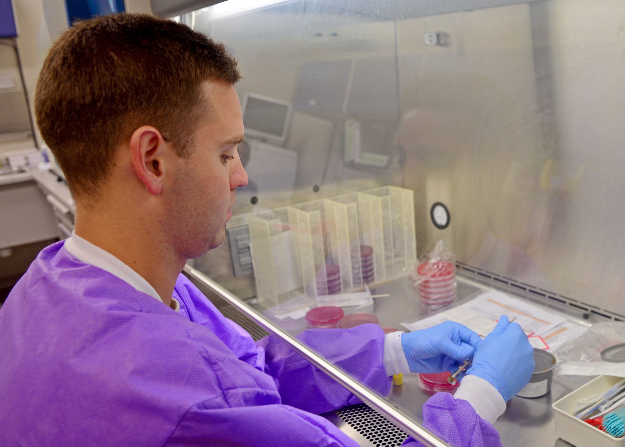 Airman 1st Class Matthew Poe, 31st Medical Support Squadron laboratory technician, transfers a stool sample, Aug. 21, 2013, at Aviano Air Base, Italy. The medical laboratory performs more than 90,000 tests a year to help diagnose illnesses and ailments while maintaining a fully functional blood bank. (U.S. Air Force photo/Airman 1st Class Briana Jones)
