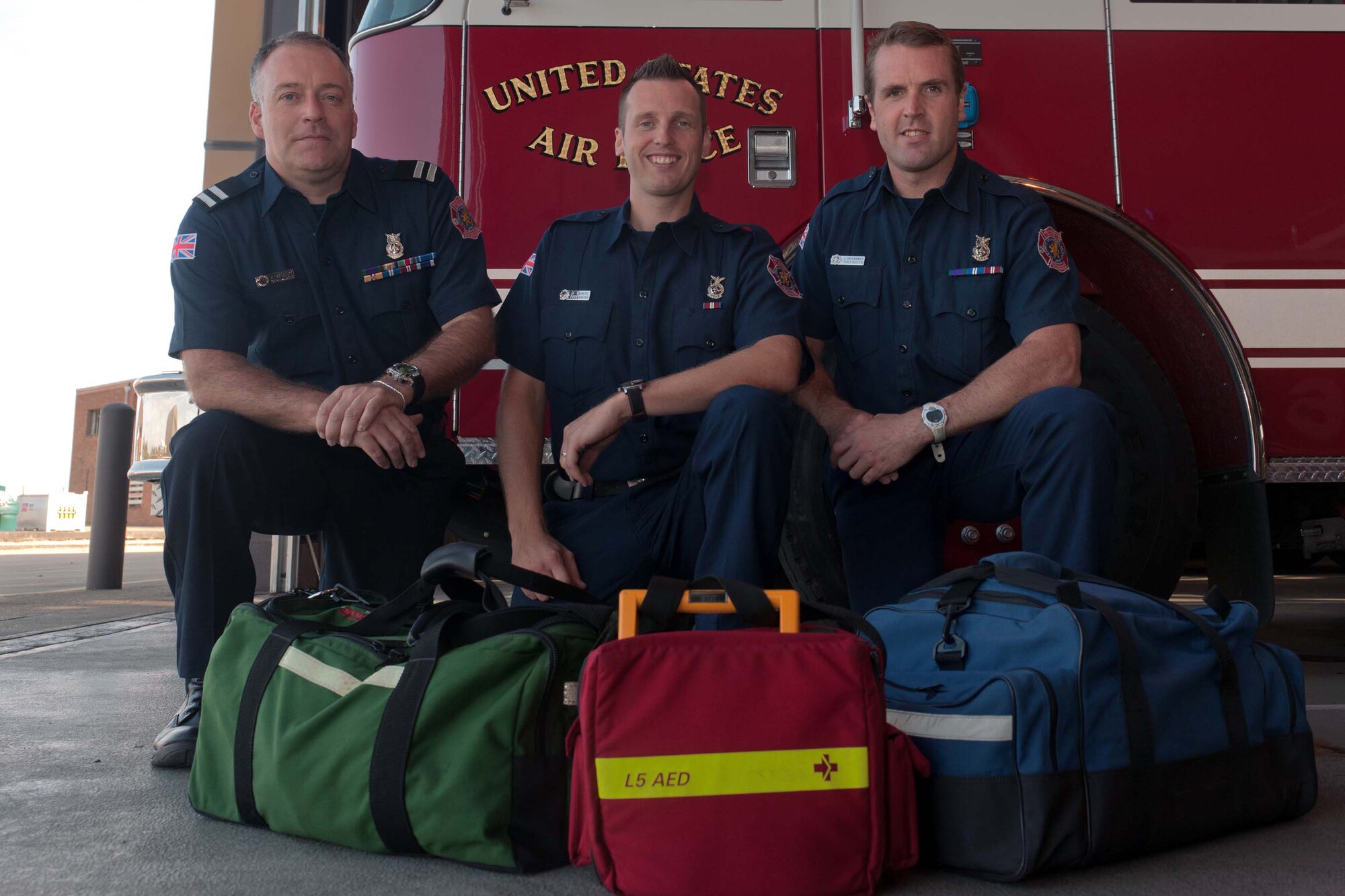 RAF ALCONBURY, United Kingdom – Crew Manager Richard Drewery and Firefighters Mark White and Jamie Greenaway were part of the seven-person crew that responded to a call about an unconscious person at the Alconbury Middle/High School Aug. 5. When the crew of seven RAF Alconbury firefighters arrived on-scene, they discovered that Dave White wasn’t breathing and his tongue was lodged in his throat. After the first responders cleared White’s airway, they began performing cardiopulmonary resuscitation. He responded quickly and started gurgling breathing on his own. Firefighters then quickly suctioned his airway until it was clear and attended to him until a host nation ambulance arrived on-scene and transported him to an off-base hospital. (U.S. Air Force photo by Staff Sgt. Brian Stives)