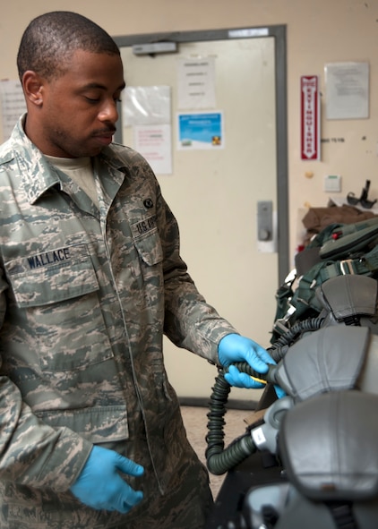Airman 1st Class Amir Wallace performs a post-flight cleaning and function check on helmets at the 379th Air Expeditionary Wing in Southwest Asia, Aug. 19, 2013. Wallace is a 379th Expeditionary Operations Support Squadron B-1B Lancer aircrew flight equipment technician deployed from Dyess Air Force Base, Texas, and hails from Newark, N.J. (U.S. Air Force photo/Bahja J. Jones) 