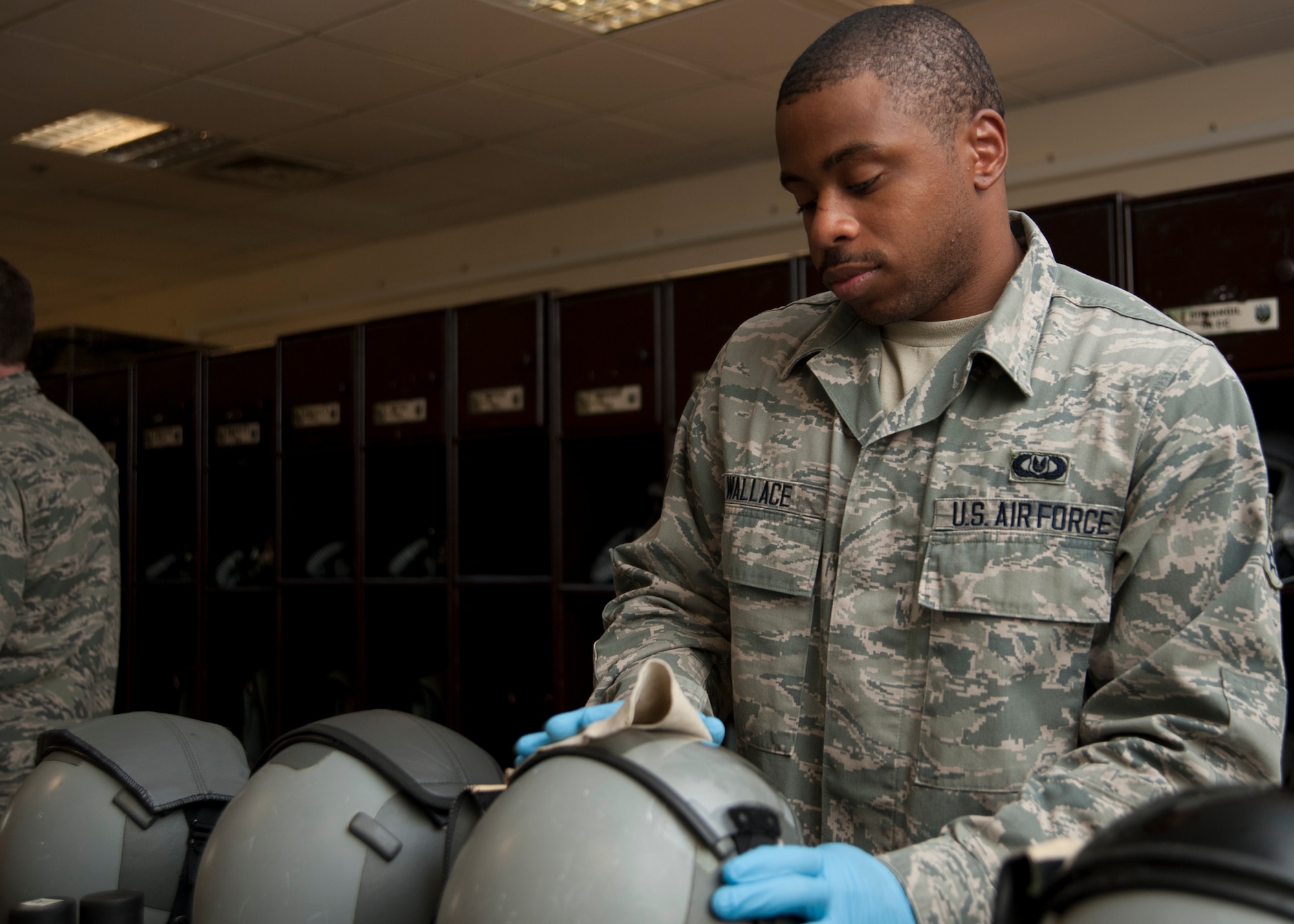 Airman 1st Class Amir Wallace performs a post-flight cleaning and function check on helmets at the 379th Air Expeditionary Wing in Southwest Asia, Aug. 19, 2013. Wallace is a 379th Expeditionary Operations Support Squadron B-1B Lancer aircrew flight equipment technician deployed from Dyess Air Force Base, Texas, and hails from Newark, N.J. (U.S. Air Force photo/Bahja J. Jones) 
