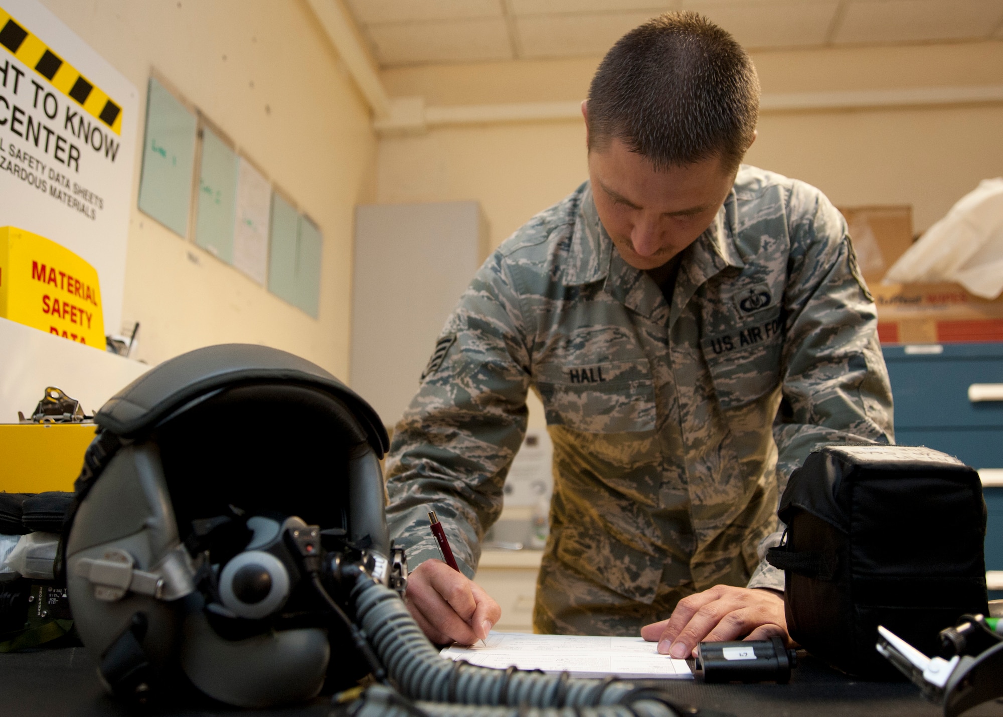 Staff Sgt. Erick Hall completes a hand receipt for returned flight equipment at the 379th Air Expeditionary Wing in Southwest Asia, Aug. 19, 2013. Hall is the 379th Expeditionary Operations Support Squadron B-1B Lancer aircrew flight equipment NCO in charge deployed from Dyess Air Force Base, Texas, and a Fort Worth, Texas, native. (U.S. Air Force photo/Senior Airman Bahja J. Jones) 