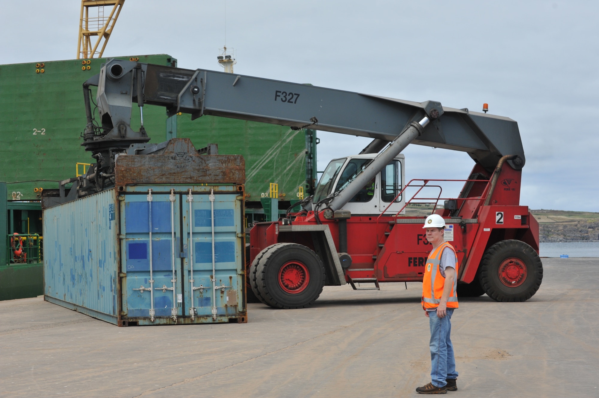 U.S. civilian Matthew Burr overseas removal of a cargo container from a sea vessel at the commercial port in Cabo da Praia, Azores, Aug. 14, to be placed onto a truck then brought to the military pier for delivery of household goods and privately owned vehicles to Lajes Airmen. Burr is the U.S. Army Military Surface Deployment and Distribution Command 838th Transportation Battalion Azores Detachment director. (U.S. Air Force photo by Staff Sgt. Angelique N. Smythe)