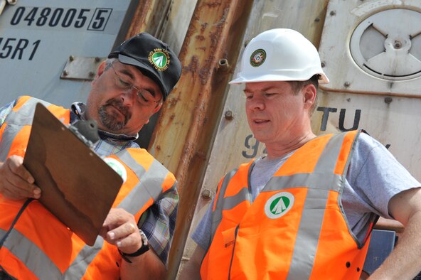 Portuguese civilian Xavier Estevas goes over shipload plans with U.S. civilian Matthew Burr at the commercial port in Cabo da Praia, Azores, Aug. 14. Burr is director and Estevas is the deputy director of the U.S. Army Military Surface Deployment and Distribution Command 838th Transportation Battalion Azores Detachment. (U.S. Air Force photo by Staff Sgt. Angelique N. Smythe)