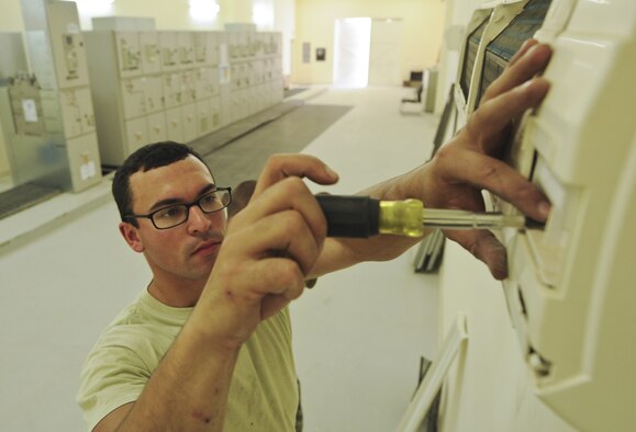 U.S. Air Force Airman 1st Class Anthony Rodriguez, 380th Expeditionary Civil Engineer Squadron heating, ventillation, and air conditioning journeyman, works on a cooling system at an undisclosed location in Southwest Asia Aug. 7, 2013. The cooling system being replaced belongs to the commercial power distribution building, which requires a constant cool temperature to keep its systems working. Rodriguez calls Chicago, Ill., home and is deployed from Eielson Air Force Base, Ala. (U.S. Air Force photo by Staff Sgt. Jacob Morgan)
