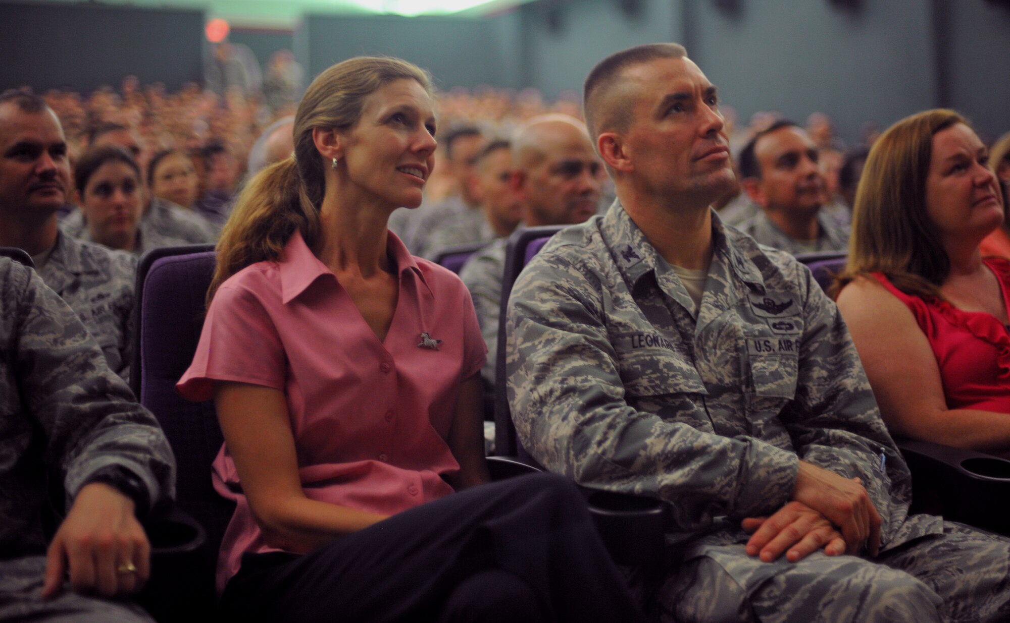 Col. Brook Leonard, 51st Fighter Wing commander, and his wife, Maria, listen to Air Force Chief of Staff Gen. Mark A. Welsh III and Chief Master Sgt. of the Air Force James A. Cody speak during an Airman’s call at Osan Air Base, Republic of Korea, Aug. 22, 2013. Welsh and Cody thanked Airmen for their continued service and dedication, and issued their three keys to success: common sense, communication and caring. (U.S. Air Force photo/Senior Airman Siuta B. Ika)