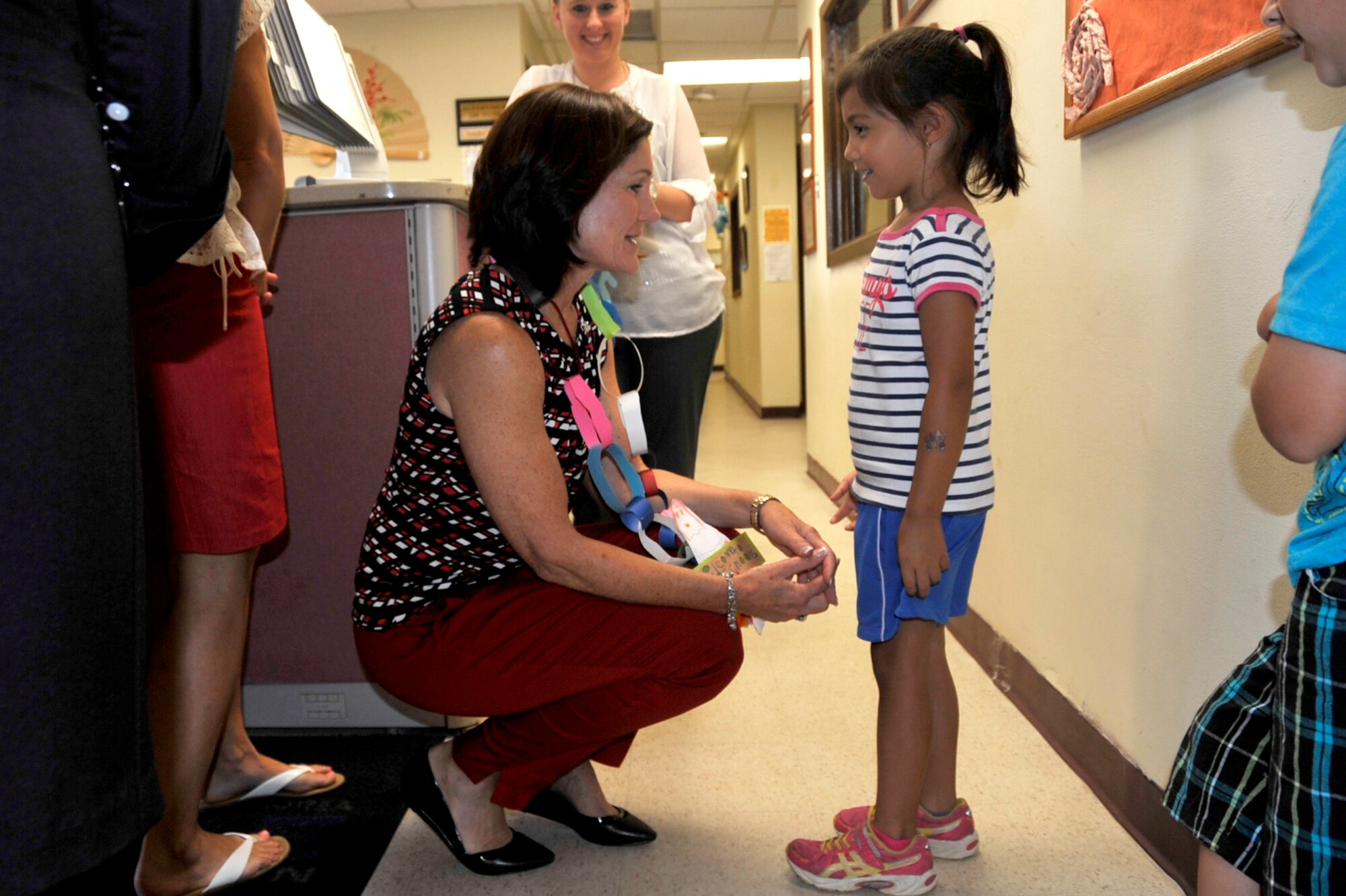 Betty Welsh, wife of Air Force Chief of Staff Gen. Mark A. Welsh III, is greeted by children at the Osan Child Development Center upon her arrival for a tour of the facility at Osan Air Base, Republic of Korea, Aug. 23, 2013. Welsh was accompanied by Athena Cody, wife of Chief Master Sgt. of the Air Force James A. Cody, as they toured the CDC to discuss and understand unique characteristics of life at Osan and the limitations for child care. Welsh and Cody joined their husbands to see Team Osan’s mission first hand, thank Airmen for their continued service and dedication, and discuss challenges and opportunities for Airmen and their families in the Pacific.