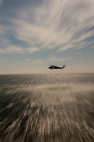 KUNSAN AIR BASE, Republic of Korea -- A UH-60 Black Hawk hovers in support of two AH-64 Apache Longbows that were conducting live-fire training, Aug. 15, 2013. The Apache pilots launched AGM-114F Hellfire Missiles during their training designed to keep them proficient in live-fire capabilities. (U.S. Air Force photo by Senior Airman Armando A. Schwier-Morales/ Released)