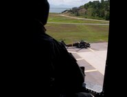 KUNSAN AIR BASE, Republic of Korea -- A U.S. Army UH-60 Black Hawk helicopter crew chief looks onto the ramp of Kunsan Air Base, Republic of Korea, where another helicopter waits to take off Aug. 15, 2013. The two helicopters supported live-fire training exercises for Army AH-Apache Longbows from Camp Humphreys, ROK. (U.S. Air Force photo by Senior Airman Armando A. Schwier-Morales/ Released)