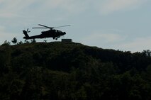KUNSAN AIR BASE, Republic of Korea -- Soldiers fly their AH-64 Apache Longbow helicopter in for landing at Kunsan Air Base, Republic of Korea Aug. 15, 2013. The Army conducts live-fire training at Jik-Do Island, which is a  range on two islands off the coast of Korea, near Kunsan. (U.S. Air Force photo by Senior Airman Armando A. Schwier-Morales/ Released)
