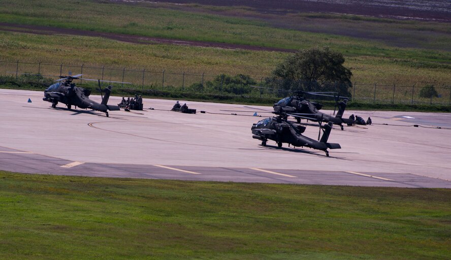 KUNSAN AIR BASE, Republic of Korea -- Soldiers from the 4th Aerial Reconnaissance Battalion (Attack), 2nd Aviation Regiment, Camp Humphreys, Republic of Korea, refuel and re-arm their AH-64 Apache Longbows at Kunsan Air Base, ROK, Aug. 15, 2013. The apaches conducted live-fire training at Jik-Do Island, a nearby training range. (U.S. Air Force photo by Senior Airman Armando A. Schwier-Morales/ Released)