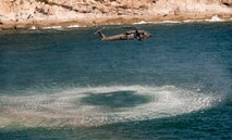 KUNSAN AIR BASE, Republic of Korea -- Soldiers from the 4th Aerial Reconnaissance Battalion (Attack), 2nd Aviation Regiment, Camp Humphreys, Republic of Korea, hover their UH-60 Black Hawk over the Yellow Sea Aug. 15, 2013. The Soldiers were documenting a pair of AH-64 Apache Longbows conducting live-fire training. (U.S. Air Force photo by Senior Airman Armando A. Schwier-Morales/ Released)