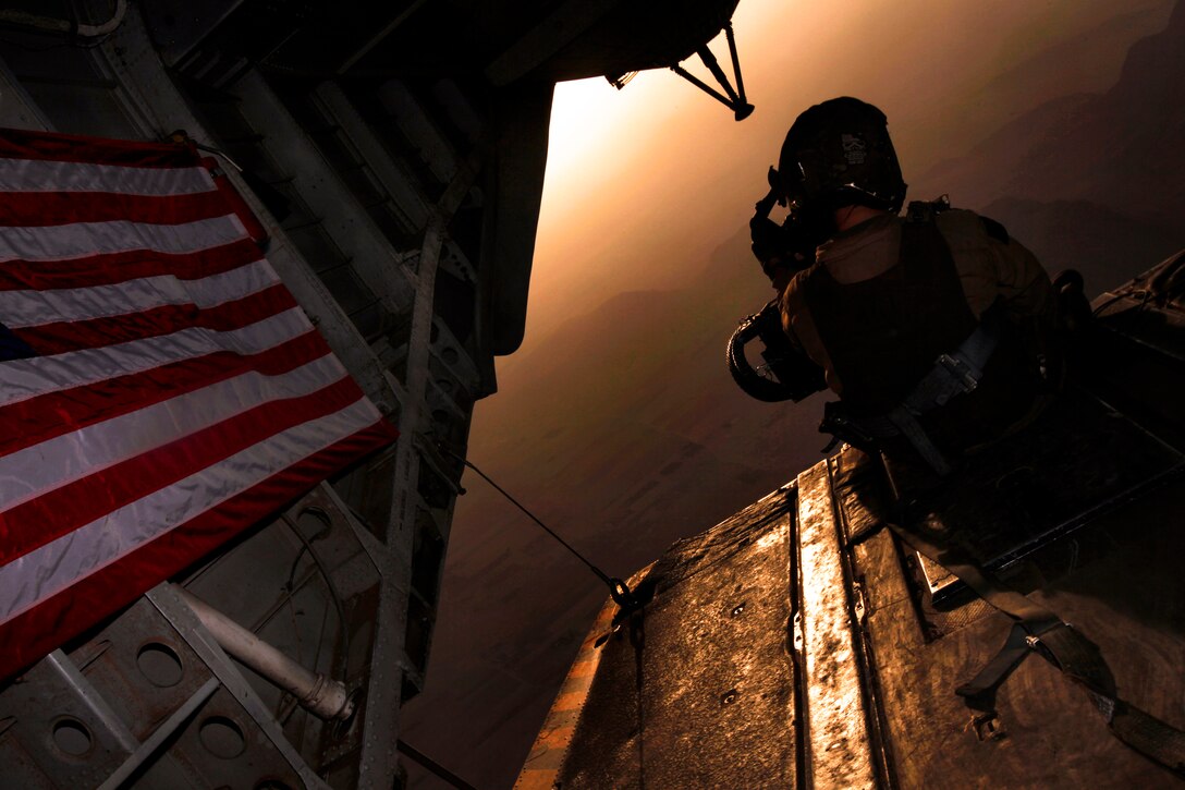 U.S. Marine Corps Staff Sgt. Peter A. Montalvo provides aerial security with a .50-caliber machine gun inside a CH-53E Super Stallion helicopter over Helmand province, Afghanistan, Aug. 20, 2013. Montalvo, a crew chief, is assigned to Marine Heavy Helicopter Squadron 461.