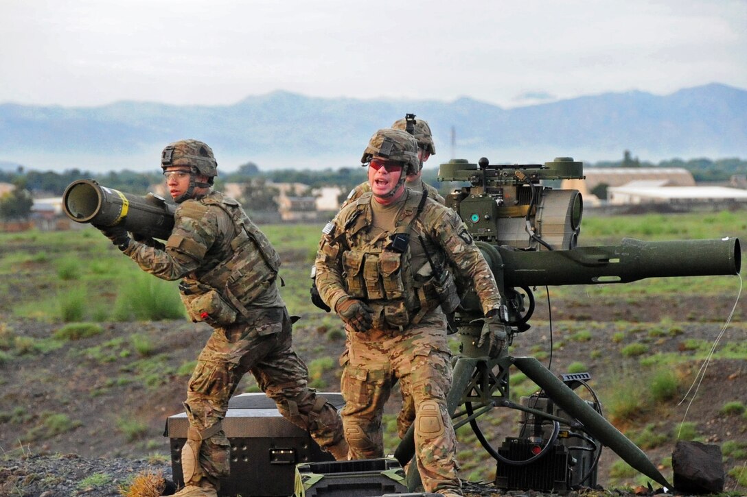U.S. Army Pfc.. Kyle Pelham, left, clears the launcher after firing a tube-launched, optically-tracked and wire-guided missile at a target as U.S. Army Cpl. Christopher Parker, center front, calls for the next soldier to fire and U.S. Army 1st Lt. Jordan Farrar observes on Forward Operating Base Salerno, Khowst province, Afghanistan, August 14, 2013. Pelham and Parker, infantrymen, and Farrar are assigned to the 101st Airborne Division's 2nd Battalion, 506th Infantry Regiment, 4th Brigade Combat Team.