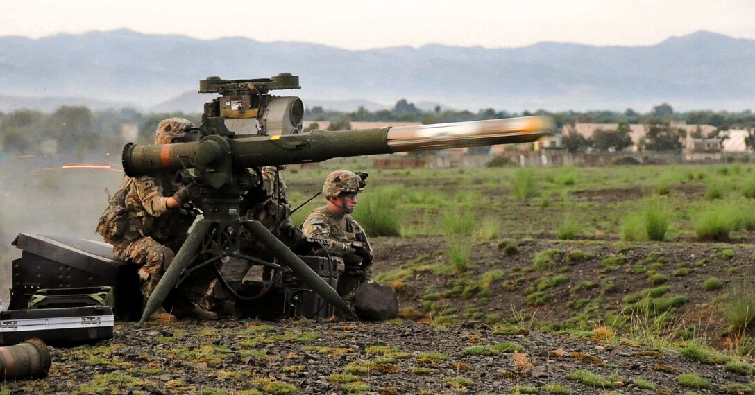 U.S. Army Spc. Adam Greiger, an infantryman, fires an tube-launched, optically-tracked and wire-guided missile at a target while U.S. Army Cpl. Christopher Parker and U.S. Army 1st Lt. Jordan Farrar observe on Forward Operating Base Salerno, Khowst province, Afghanistan, August 14, 2013. Greiger and Parker, infantrymen, and Farrar are assigned to the 101st Airborne Division's 2nd Battalion, 506th Infantry Regiment, 4th Brigade Combat Team.