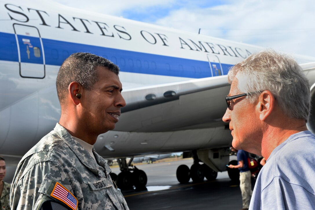 Defense Secretary Chuck Hagel speaks with Army Gen. Vincent K. Brooks, commanding general of U.S. Army Pacific, before departing Hawaii, Aug. 23, 2013, to Malaysia, Indonesia, Brunei and the Philippines to deepen cooperation with each nation and discuss regional security issues.