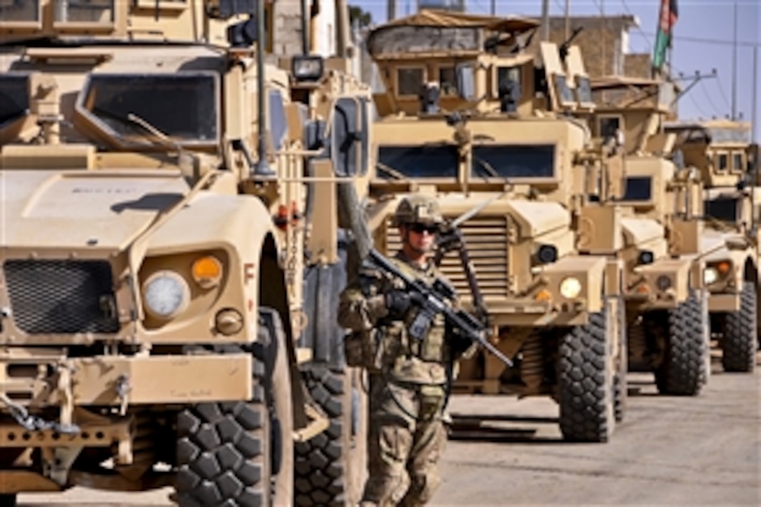 U.S. Army Pvt. Nicholas Kalinsky provides security near armored convoy vehicles as members of Provincial Reconstruction Team Farah meet at Abu Nassar Farahi High School in Farah City, Afghanistan, Aug. 21, 2013. Kalinsky is assigned to the Farah team.