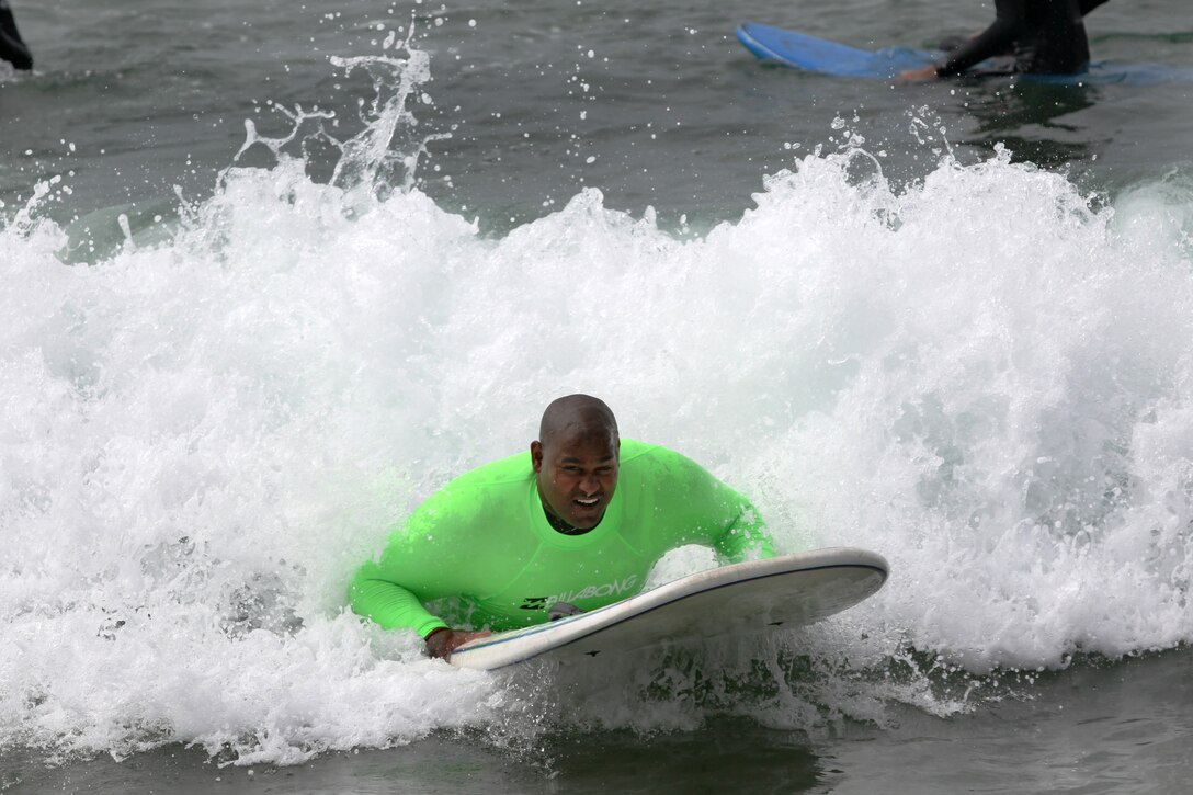 Cpl. Toran Gaal, a dpuble amputee, rides a wave during the Operation Amped surf clinic at San Onofre beach here, Aug. 24. Many veterans use surfing as an escape while others surf as a part of their new lifestyle. 