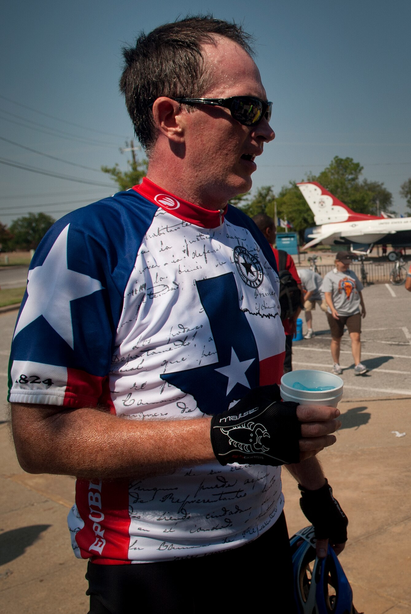 Bill Chandler, Dallas resident, takes a break at the Sheppard Air Force Base, Texas, Community Activity Center rest stop during the Hotter'N Hell Hundred bike race Aug. 24, 2013. As part of the event, Sheppard volunteers helped riders needing a break at the last rest stop before the finish line. Across all the rest stops, riders consumed more than 20,000 bananas, more than 9,000 oranges, more than 8,000 pickles, 2,800 gallons of PowerAde and 10,000 gallons of water. In all, more than 70,000 pounds of ice was also used. (U.S. Air Force photo/Staff Sgt. Mike Meares)