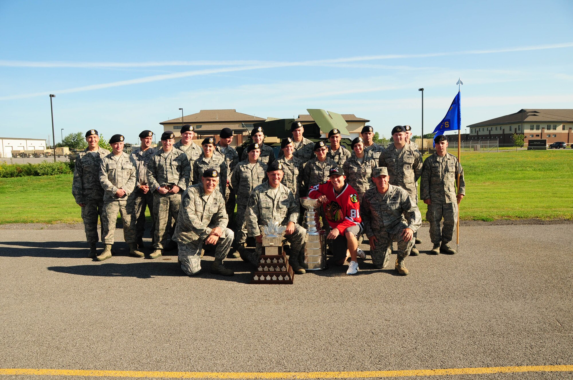 107th Airlift Wing’s Security Forces pose with Patrick Kane and the Stanley Cup and Conn Smythe trophies, they provided security and escort duties for his visit to the Niagara Falls Air Reserve Station on Aug.24, 2013. (Air National Guard Photo/ Senior Master Sgt. Ray Lloyd)