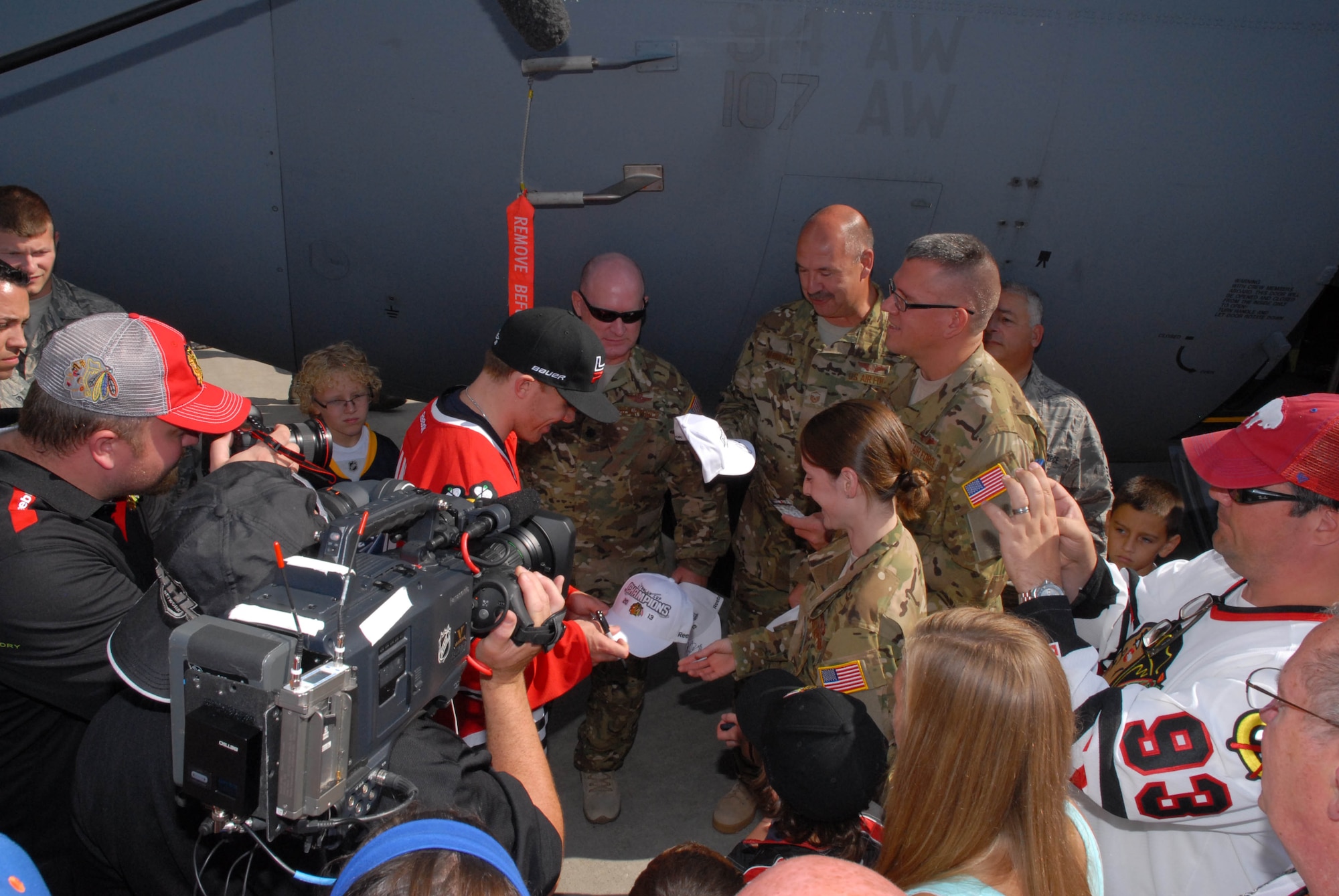 Members of the Niagara Falls Air Reserve Station meets Kane, as well as have photographs taken with the Stanley Cup and Conn Smythe trophy. Patrick Kane signs hats for 107th Airlift Wing on Aug.24, 2013. (Air National Guard Photo/ Senior Master Sgt. Stephan Kovacs)