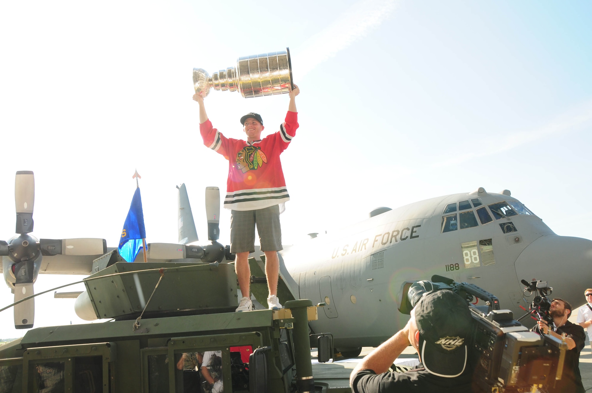 Chicago Blackhawks right wing Patrick Kane holds up the Stanley cup in front of the C-130 aircraft just before entering the hangar to greet members of the military at the Niagara Falls Air Reserve Station on Aug. 24, 2013 (Air National Guard Photo/ Senior Master Sgt. Ray Lloyd)