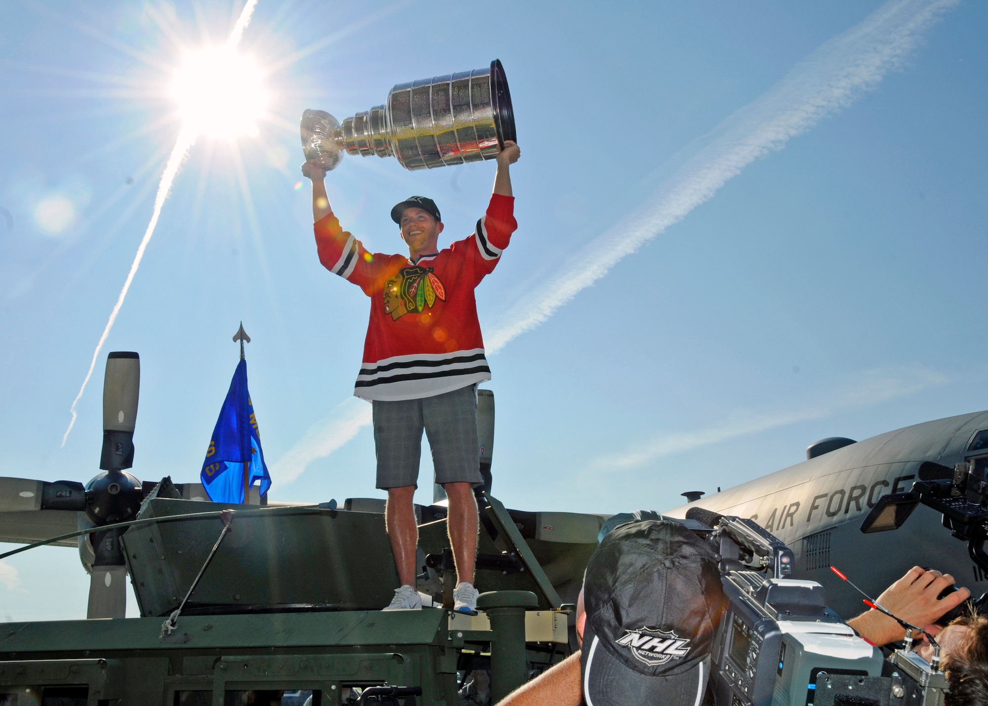 The National Hockey League Chicago Blackhawks forward and south Buffalo native Mr. Pat Kane holds the Stanley Cup above his head during a visit to the Niagara Falls Air Reserve Station, August 24, 2013, Niagara Falls, N.Y. Base personnel had the opportunity to view the Stanley Cup and Conn Smythe Trophy during Kane’s visit. (U.S. Air Force photo by Tech. Sgt. Joseph McKee)