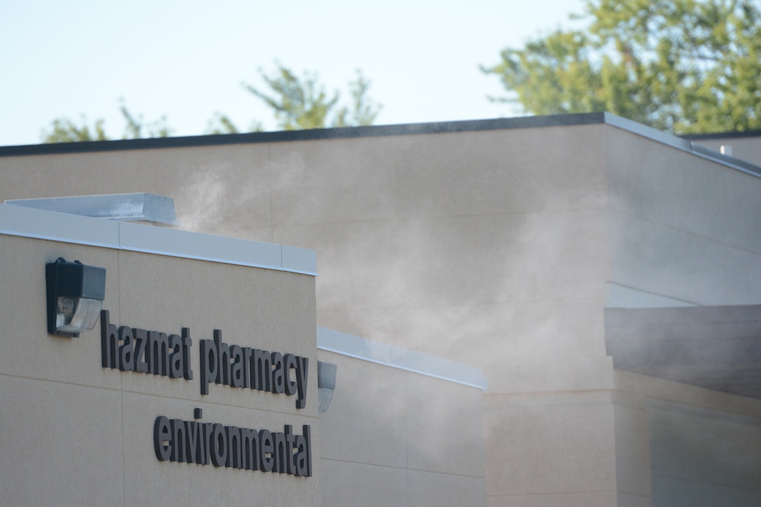 Smoke flowed from the front door of the Hazmat Pharmacy Environmental building during a bomb exercise at Truax Field, Madison, Wis., Aug. 23, 2013. The EOD team added realism by filling that building up with smoke, giving the rescue teams a challenge when removing the victims. The exercise was part of a new Air Force Inspection System initiative. (Air National Guard photo by Senior Airman Andrea F. Liechti)