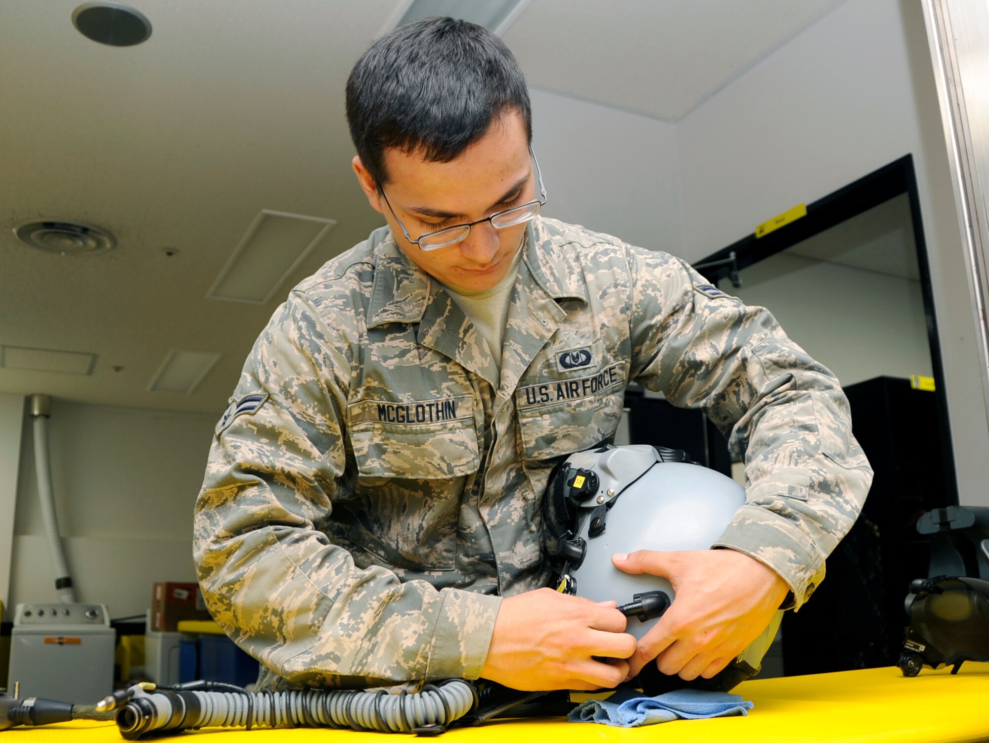 U.S. Air Force Airman 1st Class Francisco McGlothin, 35th Operations Support Squadron aircrew flight equipment technician, maintains a Joint Helmet Mounted Cueing System at Misawa Air Base, Japan, Aug. 22, 2013. A JHMCS consists of a helmet, oxygen mask and visor, and they must be inspected every 30 days to ensure all components are serviceable. (U.S. Air Force photo by Airman 1st Class Kaleb Snay)